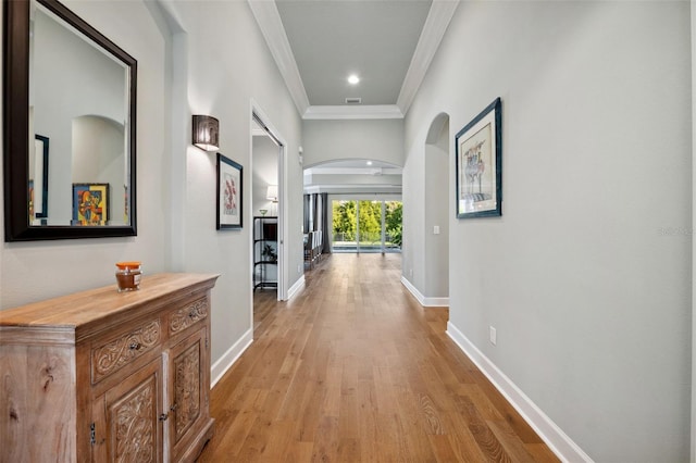 corridor with crown molding and light hardwood / wood-style floors