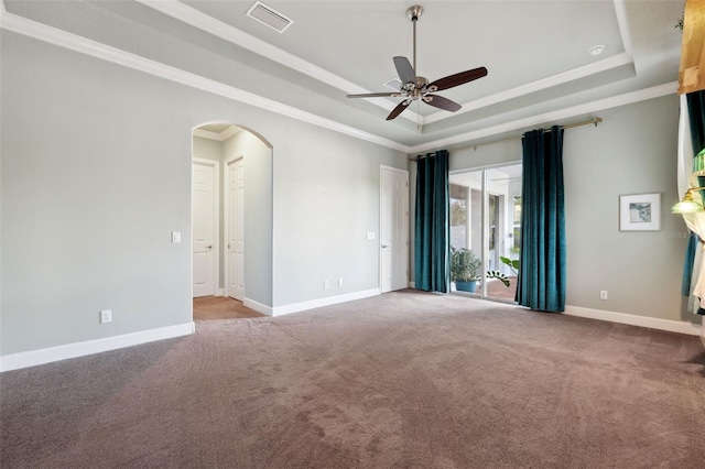 unfurnished room featuring ornamental molding, a tray ceiling, and light carpet