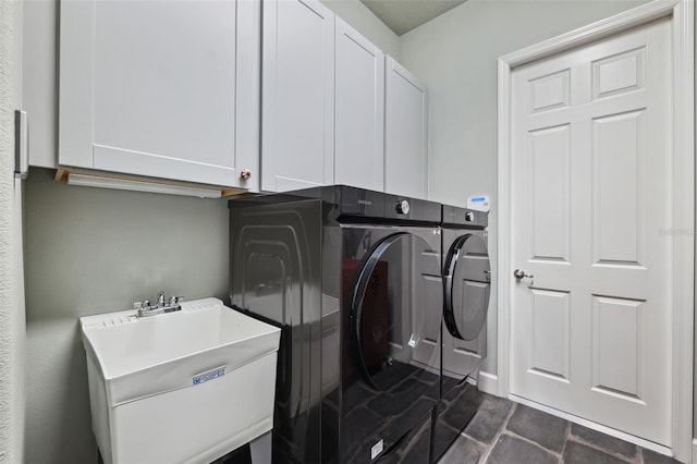 laundry room featuring cabinets, sink, and washer and dryer