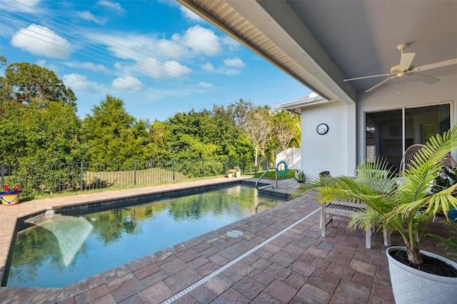 view of swimming pool with ceiling fan and a patio