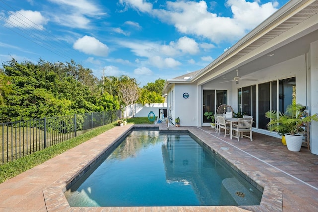 view of swimming pool with ceiling fan and a patio area