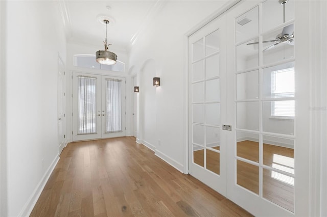 34 Concord Dr, Dunedin, FL 34698 - entrance foyer featuring french doors, ornamental molding, wood finished floors, and baseboards