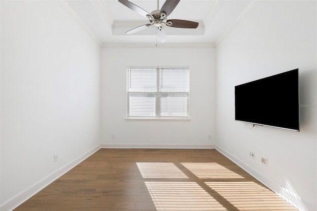 34 Concord Dr, Dunedin, FL 34698 - unfurnished living room featuring ornamental molding, wood finished floors, a ceiling fan, baseboards, and a raised ceiling