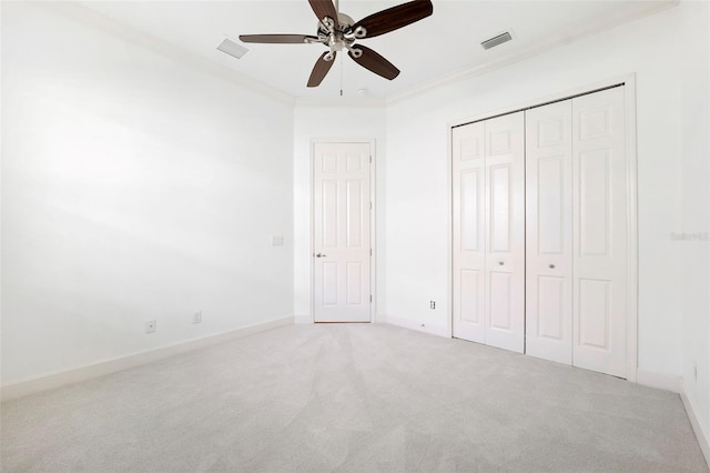 34 Concord Dr, Dunedin, FL 34698 - unfurnished bedroom featuring carpet, a closet, ornamental molding, baseboards, and ceiling fan