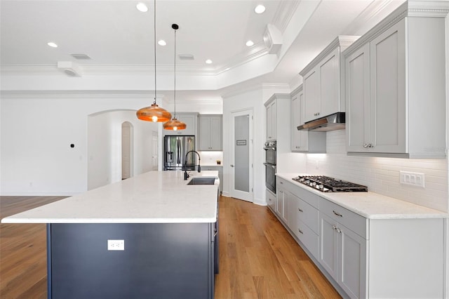 34 Concord Dr, Dunedin, FL 34698 - kitchen with appliances with stainless steel finishes, a sink, ornamental molding, under cabinet range hood, and arched walkways