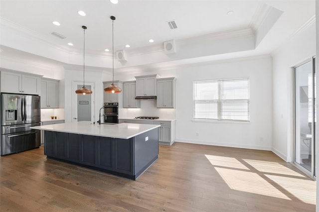 34 Concord Dr, Dunedin, FL 34698 - kitchen with stainless steel refrigerator with ice dispenser, gray cabinetry, a raised ceiling, ornamental molding, and tasteful backsplash