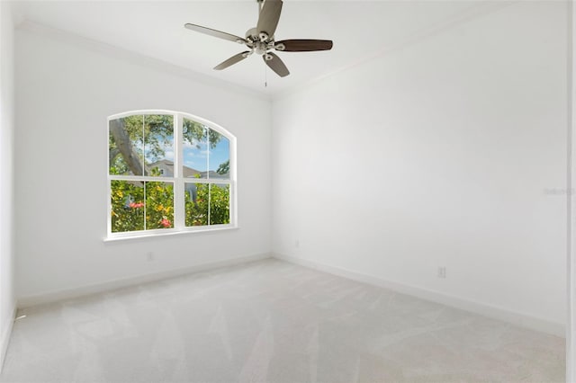 34 Concord Dr, Dunedin, FL 34698 - empty room featuring healthy amount of natural light, light colored carpet, baseboards, ceiling fan, and crown molding