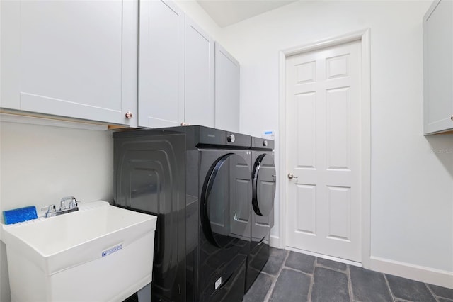 34 Concord Dr, Dunedin, FL 34698 - laundry room featuring washing machine and clothes dryer, cabinet space, and baseboards