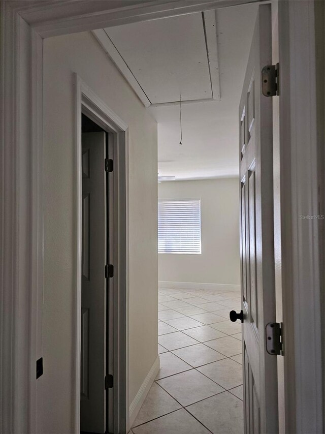 hall featuring light tile patterned floors