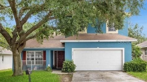 view of front of property featuring a front yard and a garage