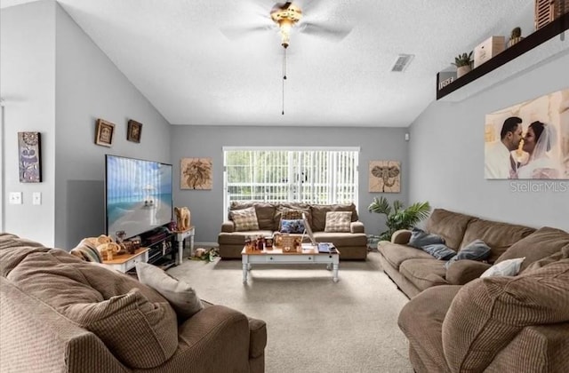 living room with carpet flooring, a textured ceiling, ceiling fan, and lofted ceiling