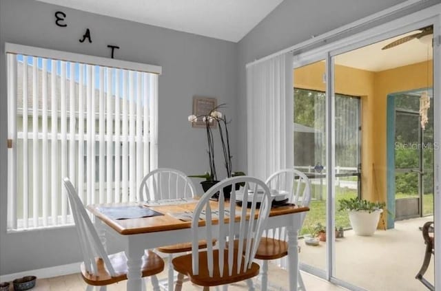 dining room with ceiling fan and vaulted ceiling