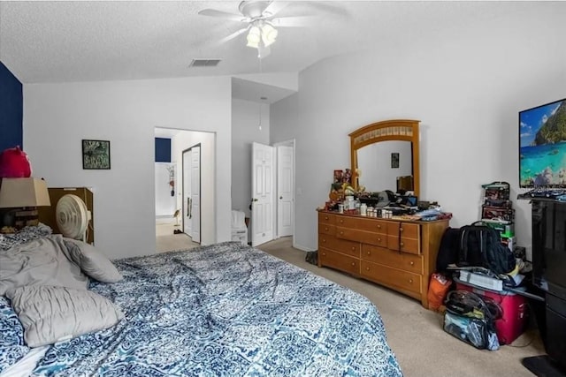 carpeted bedroom with a textured ceiling, ceiling fan, and lofted ceiling