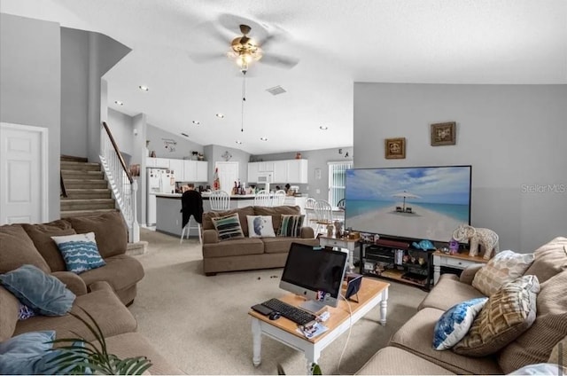 living room with ceiling fan, light colored carpet, and high vaulted ceiling