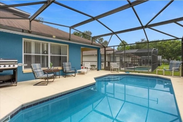 view of pool featuring a lanai, a patio area, and a grill