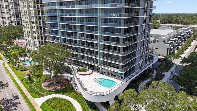 view of building exterior featuring a community pool