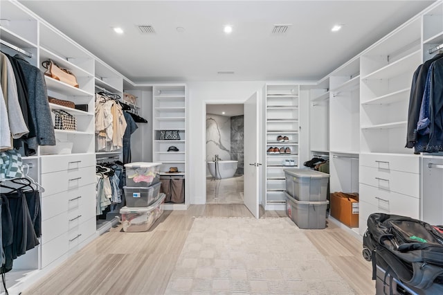 spacious closet featuring light wood-type flooring