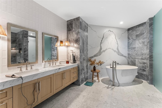 bathroom with a bathing tub, vanity, and tile walls