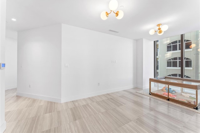 unfurnished room with a chandelier