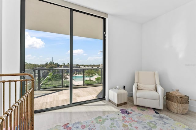 2912 W Santiago St Unit 404, Tampa, FL 33629 - sitting room featuring wood finished floors, floor to ceiling windows, and baseboards