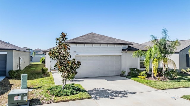 ranch-style home with a garage and a front lawn