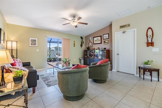 living room featuring ceiling fan, light tile patterned floors, and vaulted ceiling