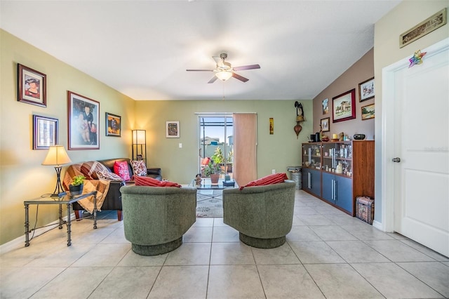 tiled living room with ceiling fan and vaulted ceiling