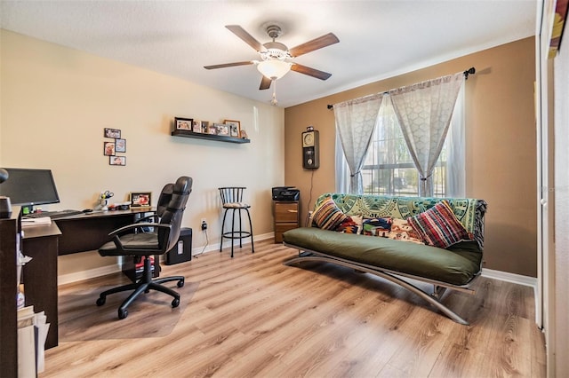 office area with light hardwood / wood-style flooring and ceiling fan