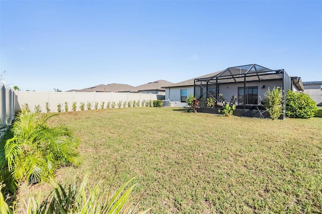 view of yard with glass enclosure