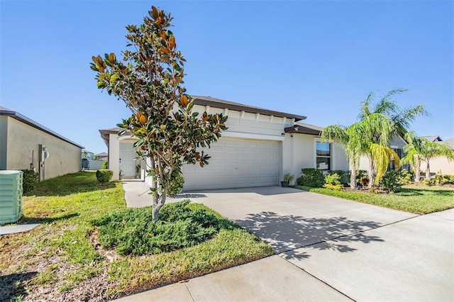 view of front of property with a garage and a front lawn