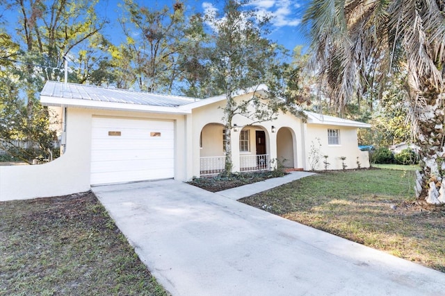 ranch-style home featuring covered porch, a garage, and a front lawn