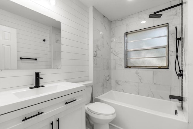 full bathroom with vanity, toilet, tiled shower / bath, and wood walls