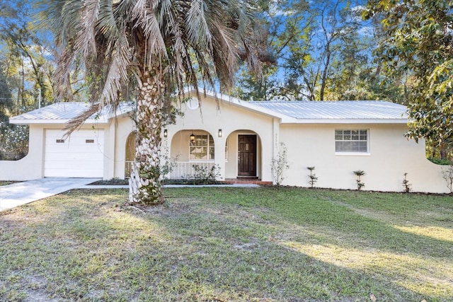 single story home featuring a front yard, a porch, and a garage