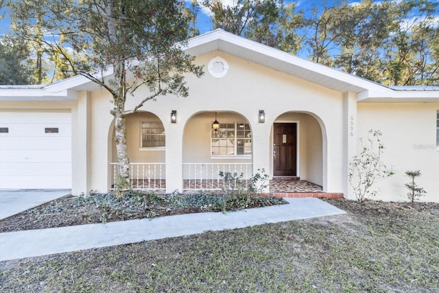 ranch-style house featuring a garage and covered porch