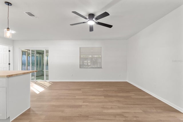 unfurnished room with ceiling fan and light hardwood / wood-style flooring