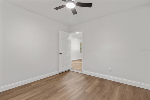 empty room featuring ceiling fan and light hardwood / wood-style floors