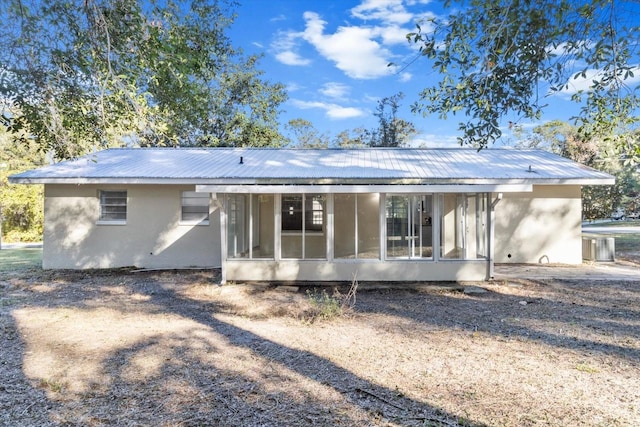 back of property featuring a sunroom