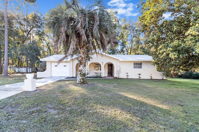 ranch-style home featuring a garage and a front lawn