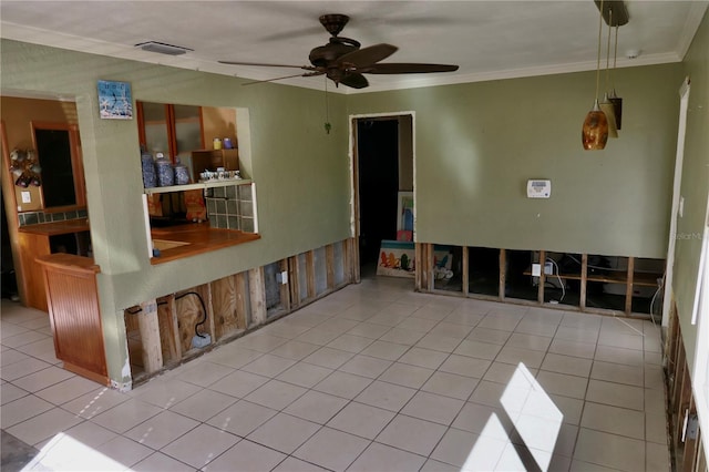 unfurnished room featuring light tile patterned floors, ceiling fan, and crown molding