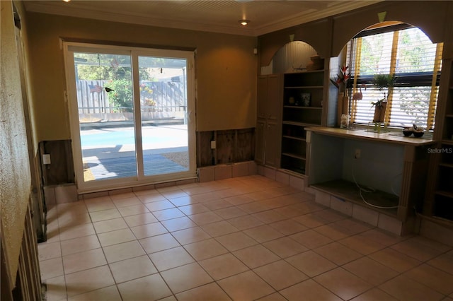 interior space featuring ornamental molding and light tile patterned floors