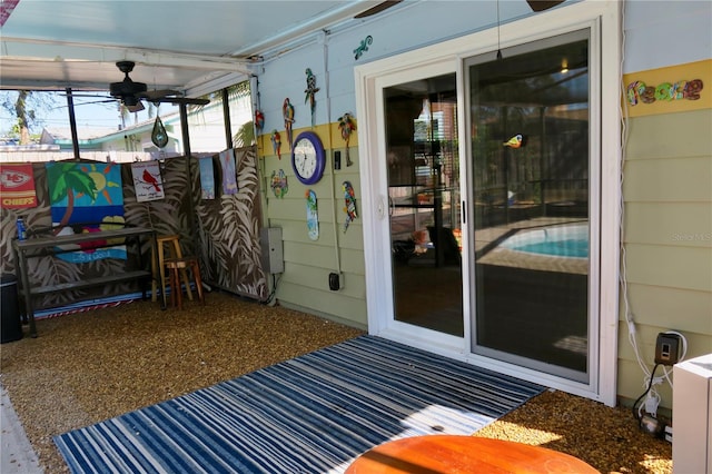 sunroom featuring ceiling fan