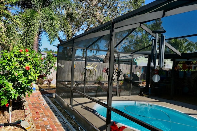 view of pool featuring glass enclosure