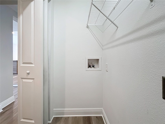 washroom with hookup for a washing machine and dark hardwood / wood-style floors