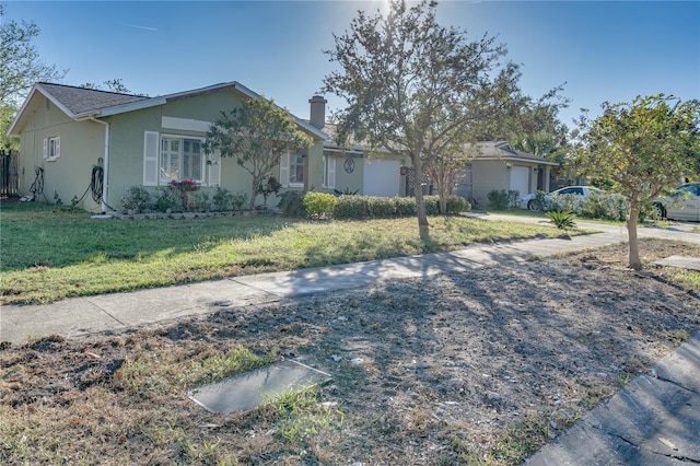 single story home with a garage and a front lawn