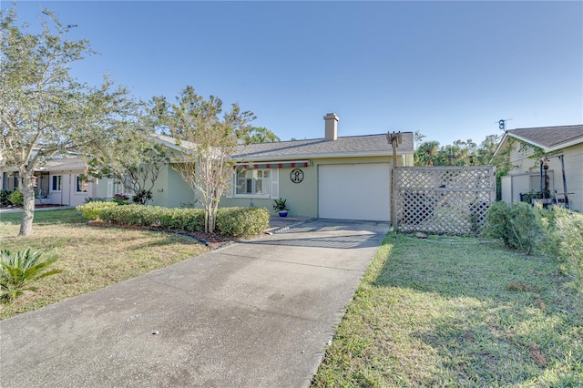 view of front of property featuring a front yard and a garage