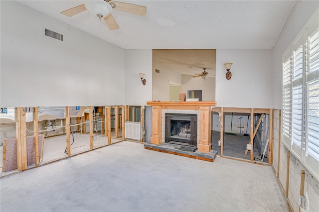 unfurnished living room featuring a textured ceiling and concrete floors