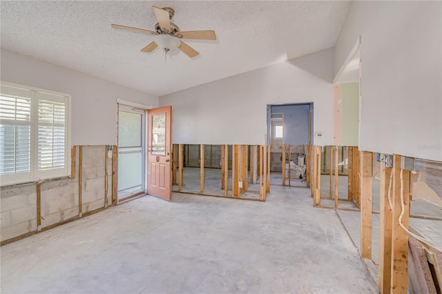 unfurnished room with ceiling fan, plenty of natural light, and a textured ceiling