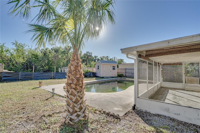 view of pool featuring a patio, a storage unit, and a sunroom