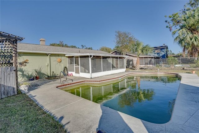 view of pool featuring a sunroom and a patio