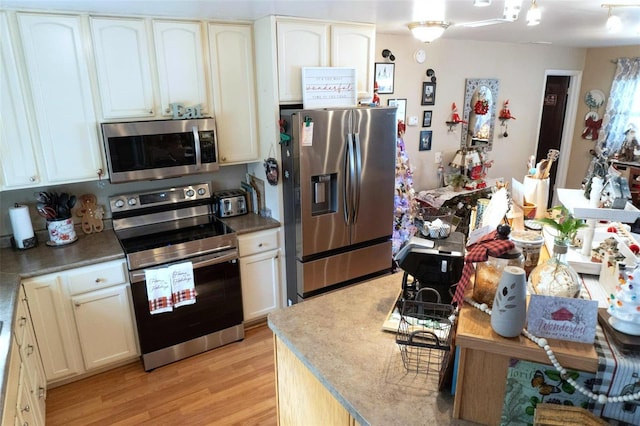 kitchen featuring stainless steel appliances and light wood-type flooring